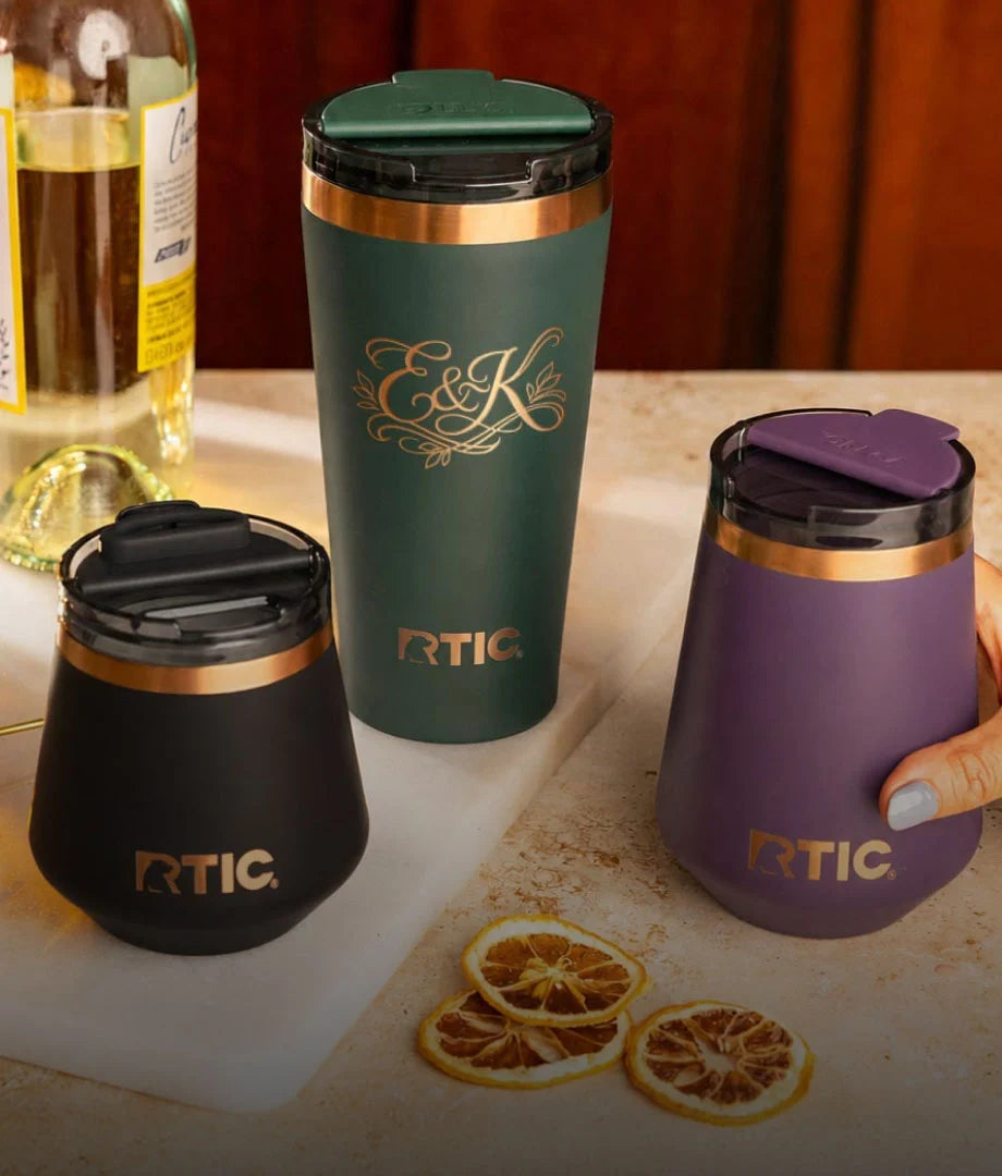 A group of RTIC Happy Hour barware in navy, dark green, and purple.